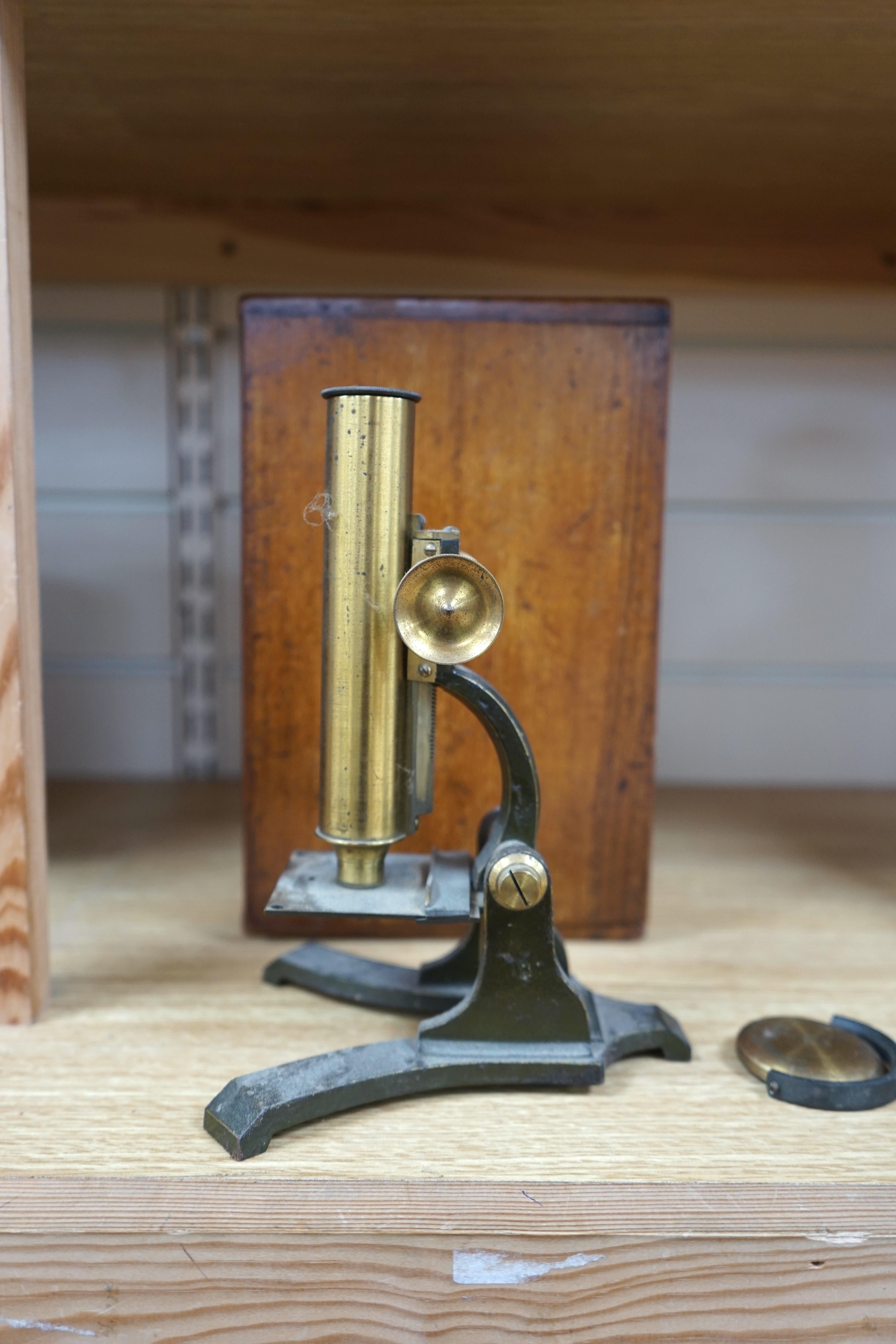 A Victorian brass microscope, J T Slugg, Manchester, in original wooden case, with a small selection of slides. Condition - fair, untested